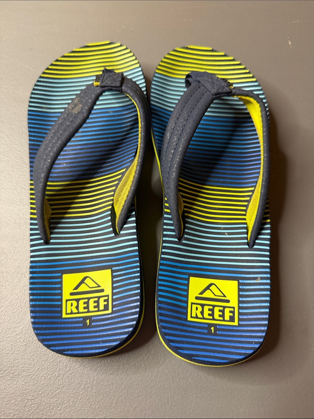 Kid’s Reef Blue & Yellow Striped Flip Flops. Size: 1